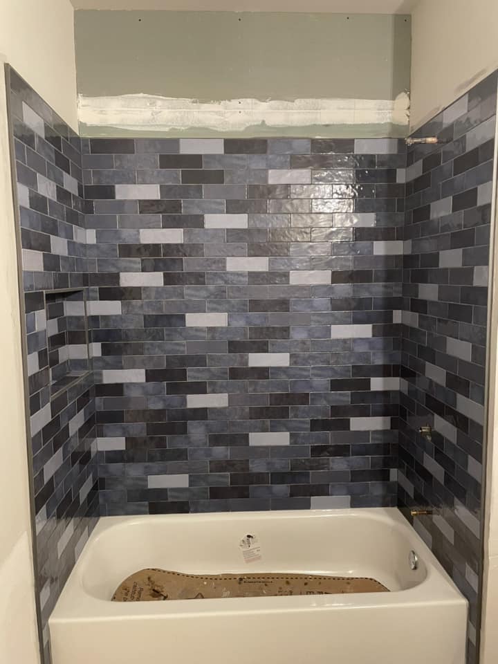 Blue subway tile shower and tub surround by Peter's Tile