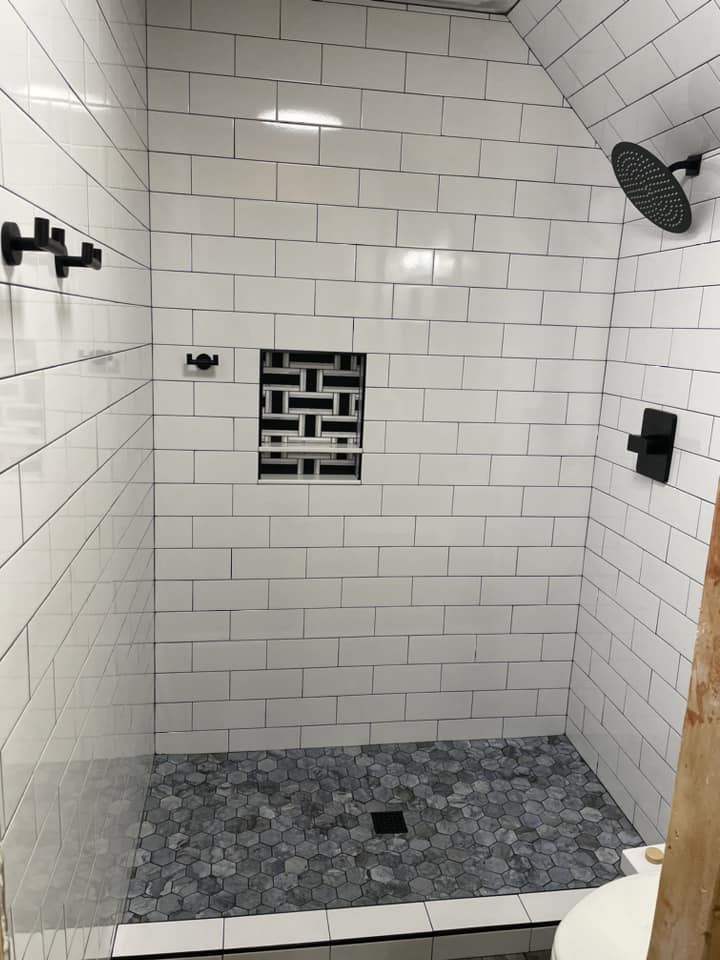 White subway tile shower with hex mosaic floor by Peter's Tile