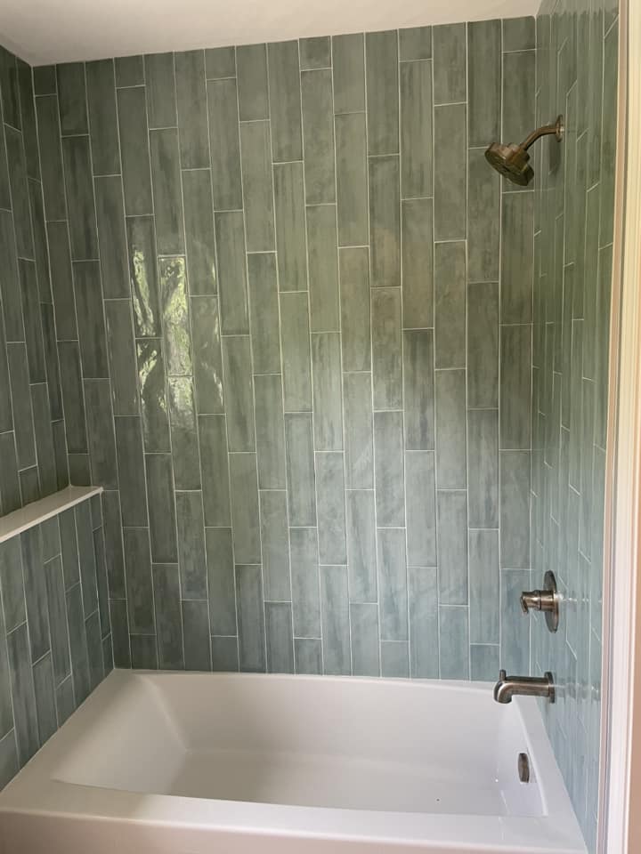 Green vertical tile bathtub surround by Peter's Tile