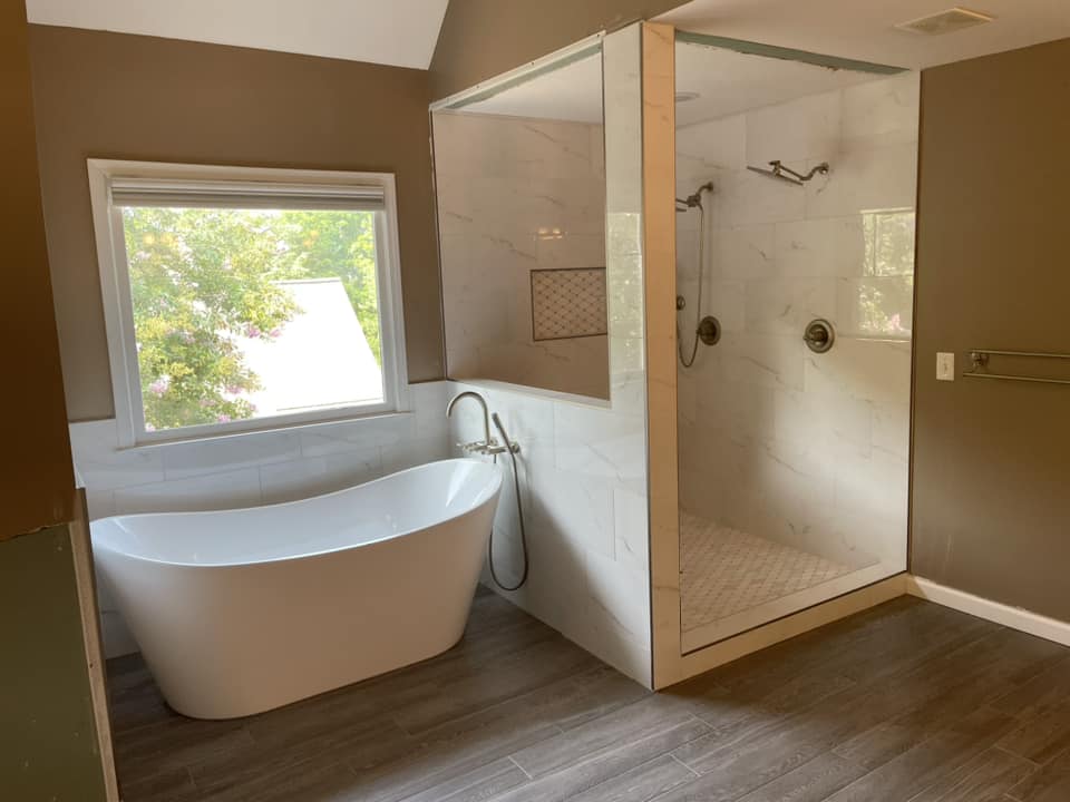 Freestanding tub with marble shower stall by Peter's Tile